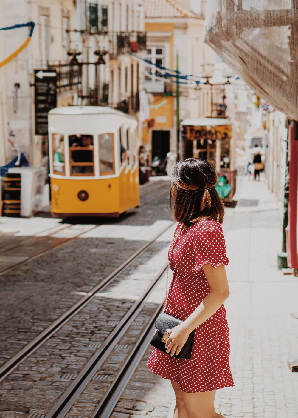 Person standing next to a tram.